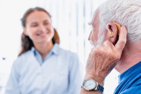 An old man is wearing hearing aid in Naples and Estero, FL