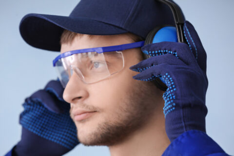 A man wearing headphones to protect the noise and transparent spectacles in Naples and Estero, FL
