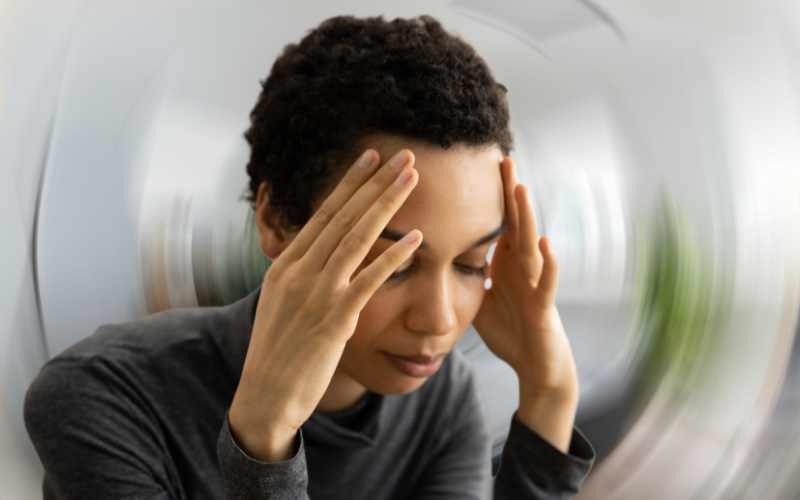 Person exhibiting signs of tinnitus, in need of treatment