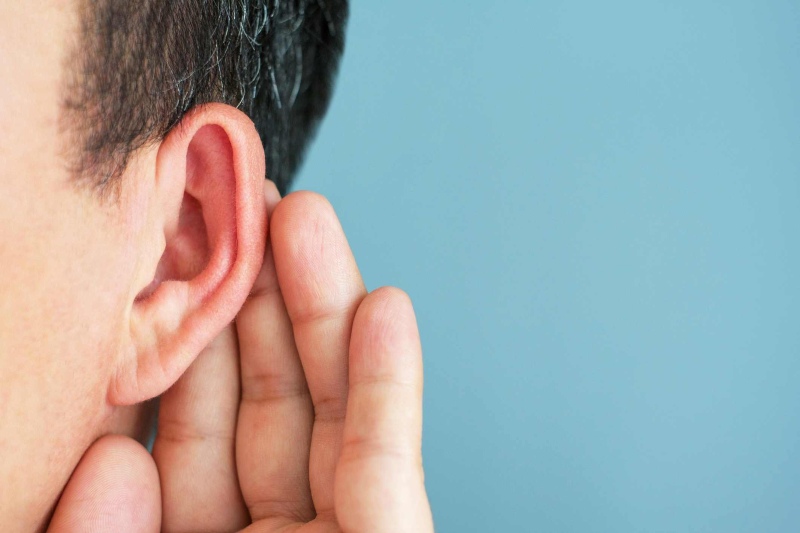 Signs of Hearing Loss A man cupping his ear as he struggles to hear, indicating signs of hearing loss in Estero, FL